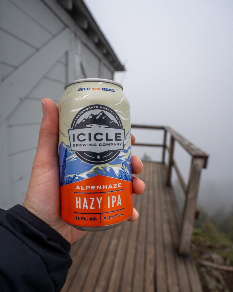 Person holding a can of Icicle Brewing Company Hazy IPA