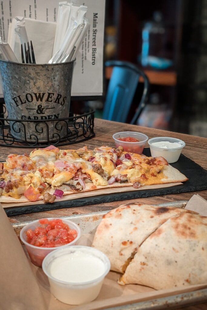 Breakfast burrito and a wrap on a table at main street bistro